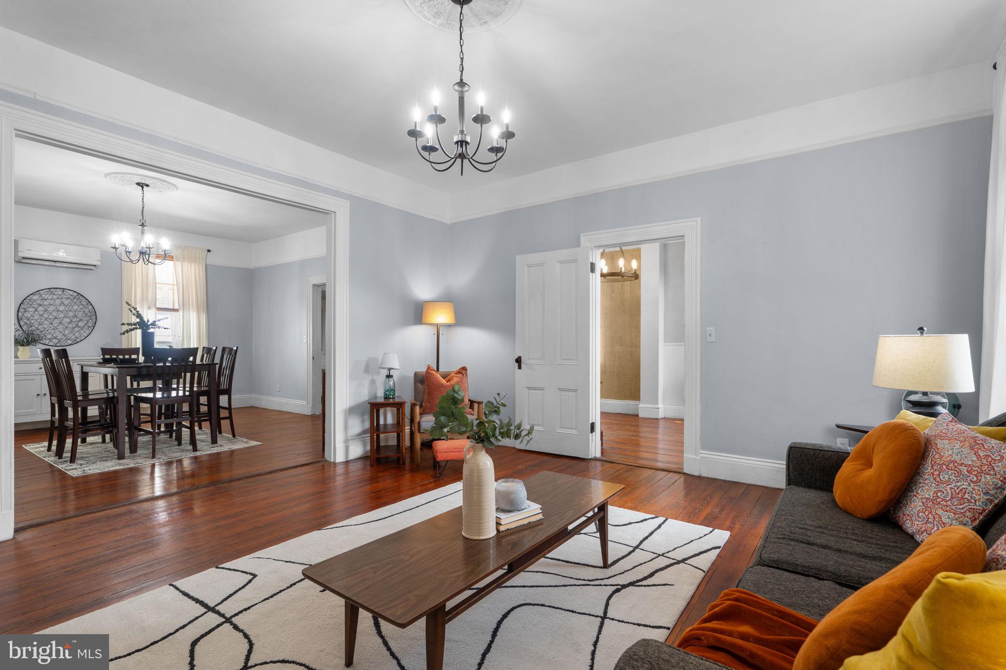 10007 Croom Road Upper Marlboro, MD 20772 - Photo 12 of 134 a living room with furniture and a chandelier
