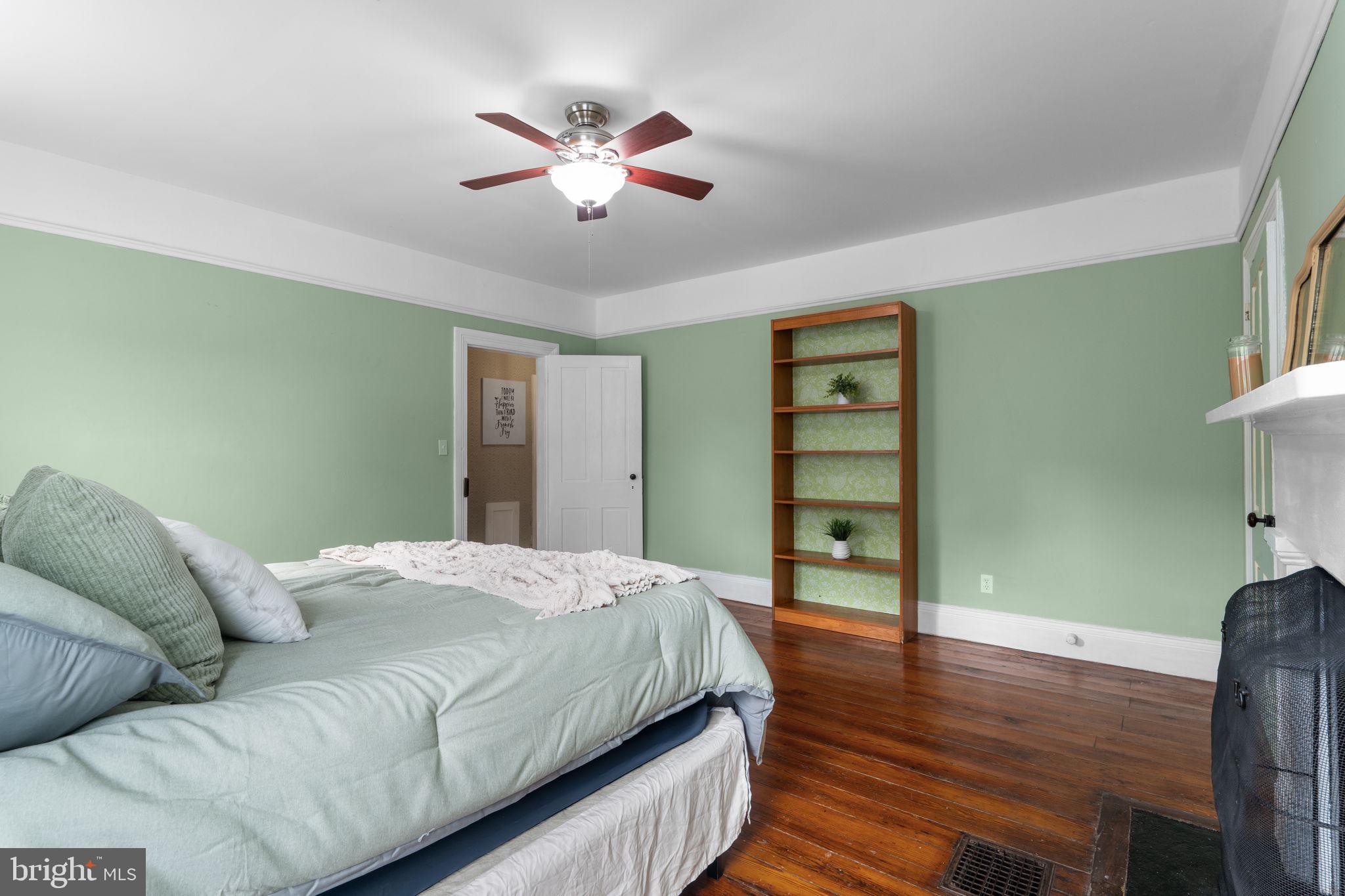 10007 Croom Road Upper Marlboro, MD 20772 - Photo 130 of 134 a spacious bedroom with a bed and a chandelier