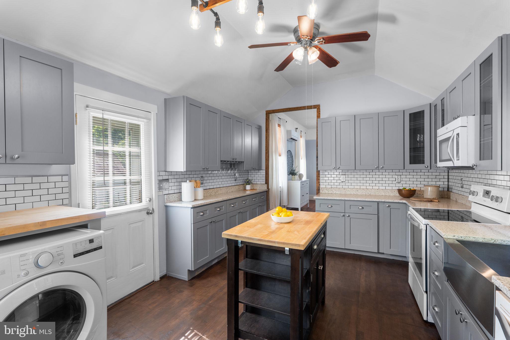 10007 Croom Road Upper Marlboro, MD 20772 - Photo 20 of 134 a kitchen that has a cabinets counter space appliances and a window