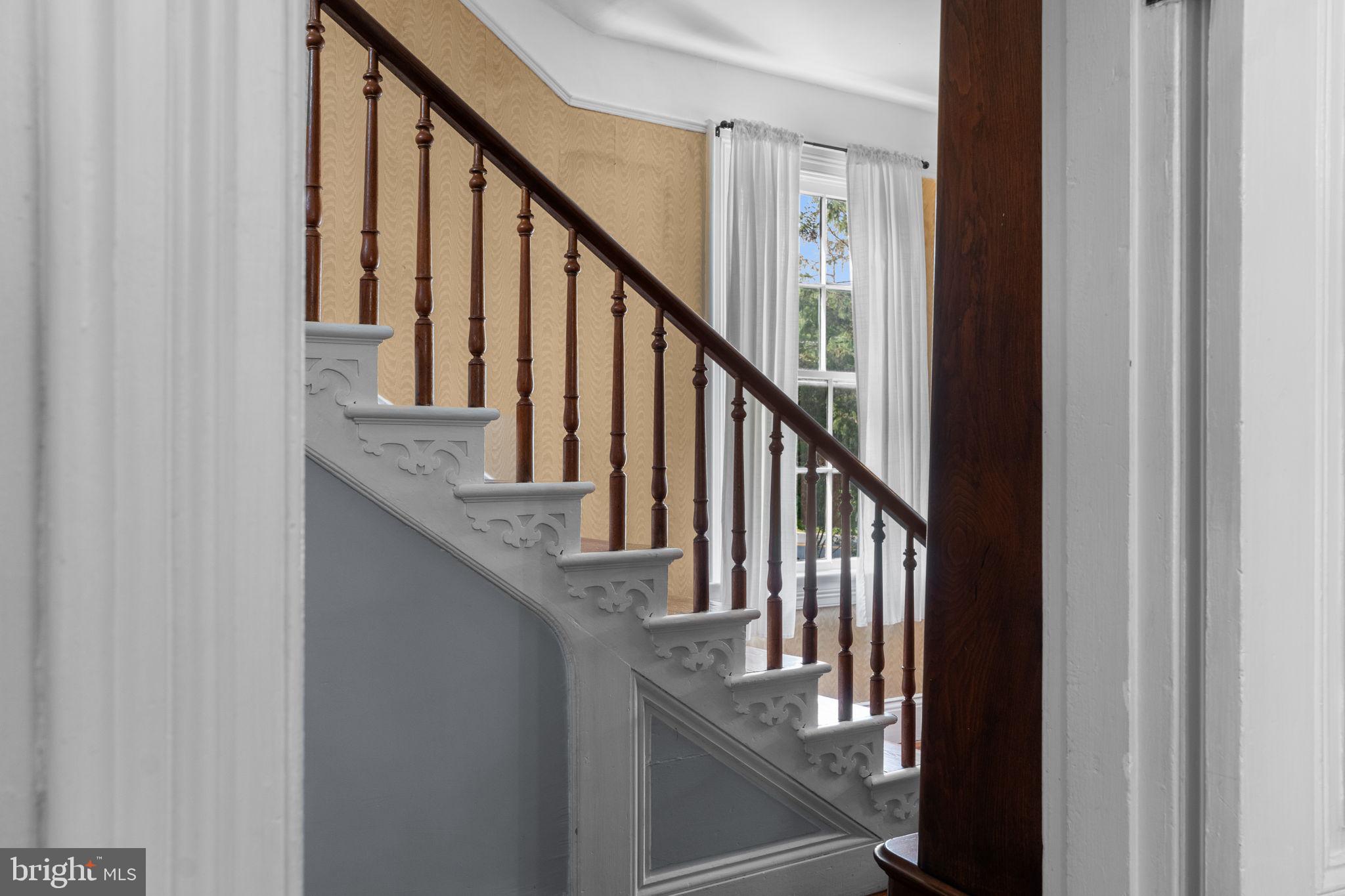 10007 Croom Road Upper Marlboro, MD 20772 - Photo 32 of 134 a view of staircase with wooden floor and white walls