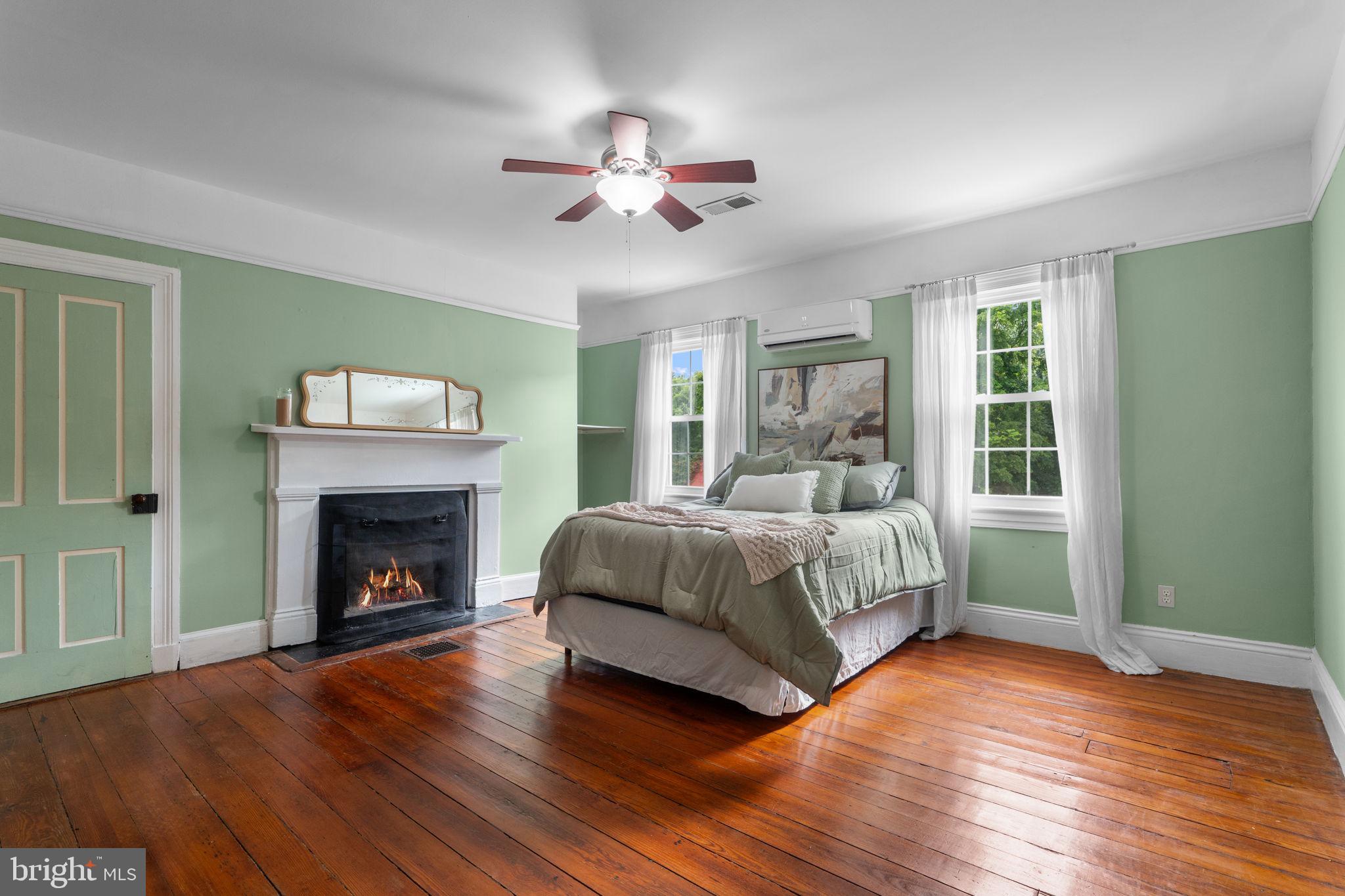 10007 Croom Road Upper Marlboro, MD 20772 - Photo 36 of 134 a bedroom with a bed and a fireplace