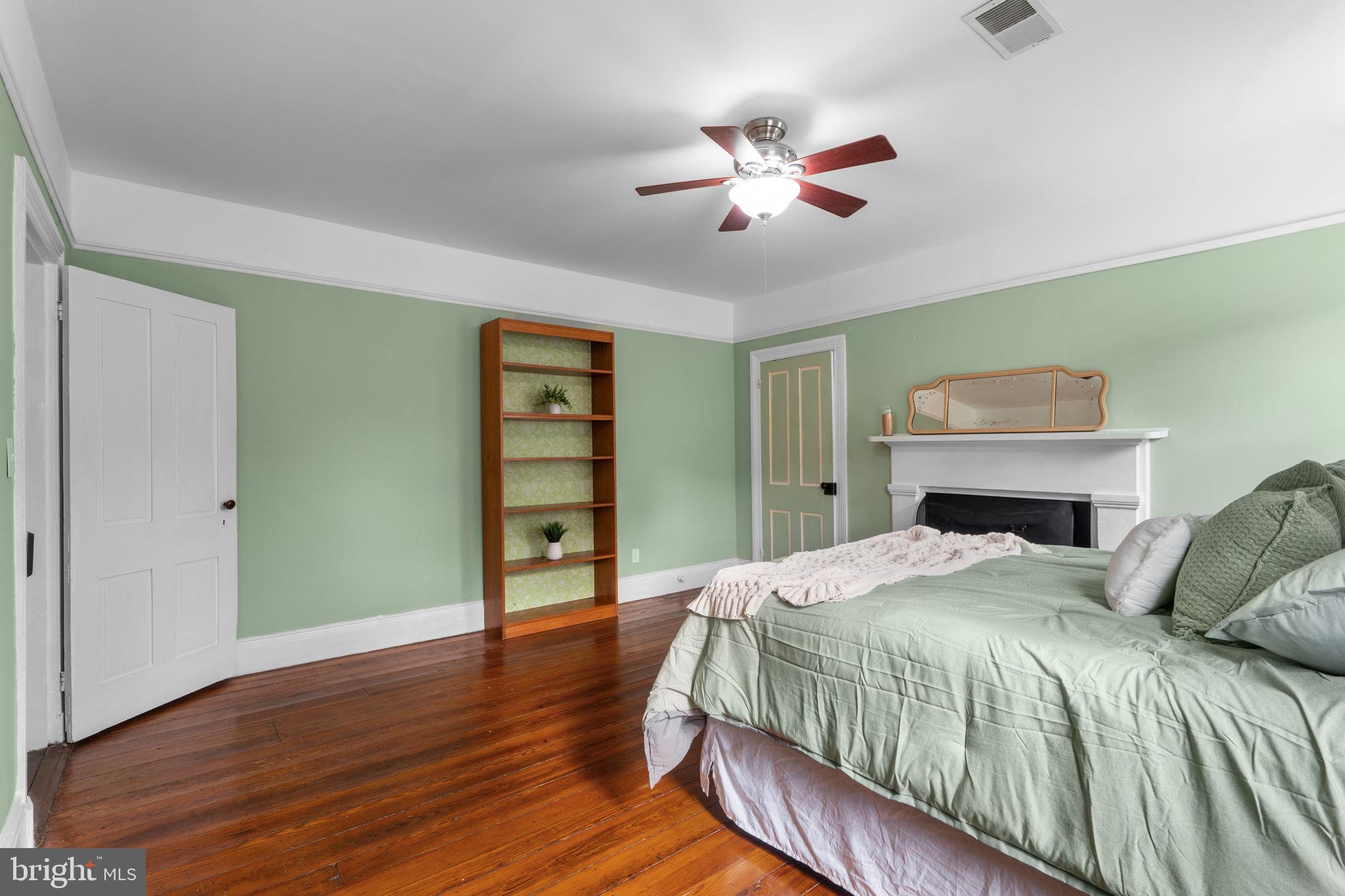 10007 Croom Road Upper Marlboro, MD 20772 - Photo 37 of 134 a bedroom with a bed and a chandelier