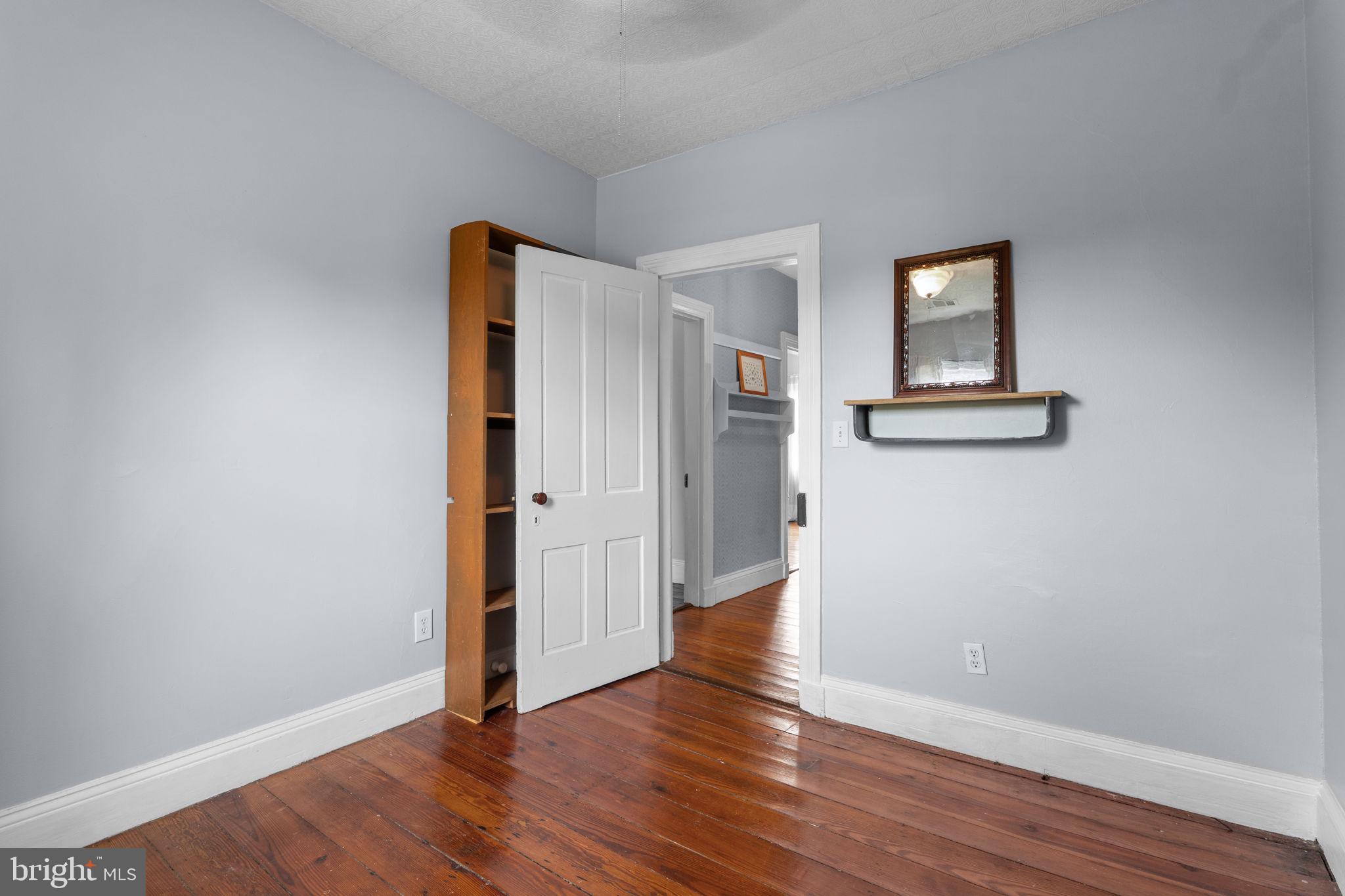 10007 Croom Road Upper Marlboro, MD 20772 - Photo 41 of 134 an empty room with wooden floor and a window