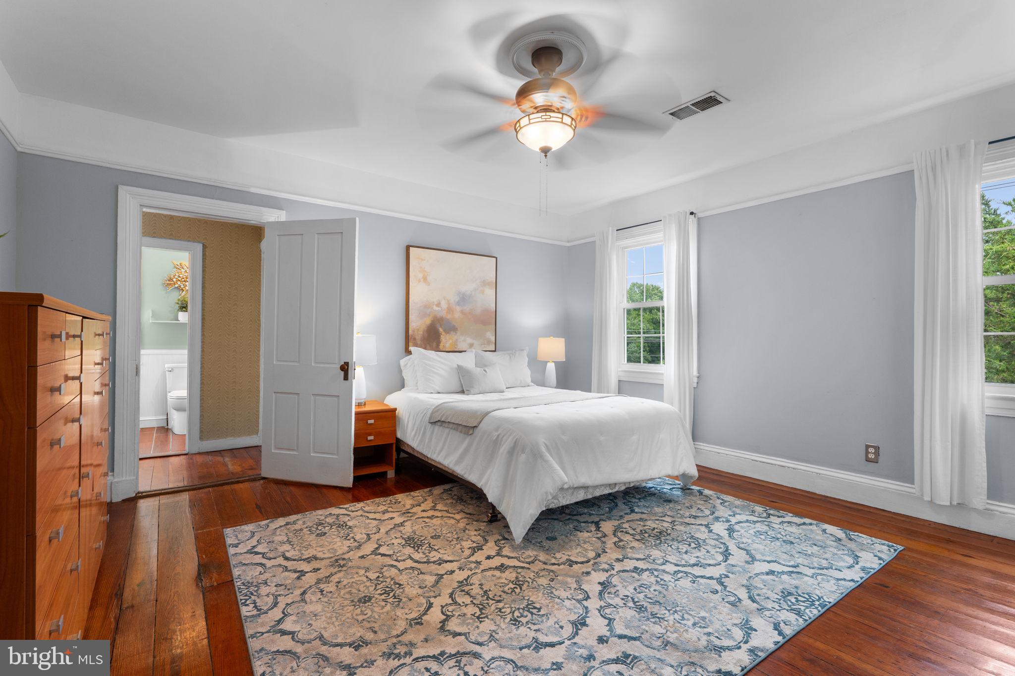 10007 Croom Road Upper Marlboro, MD 20772 - Photo 48 of 134 a bedroom with a bed and a chandelier