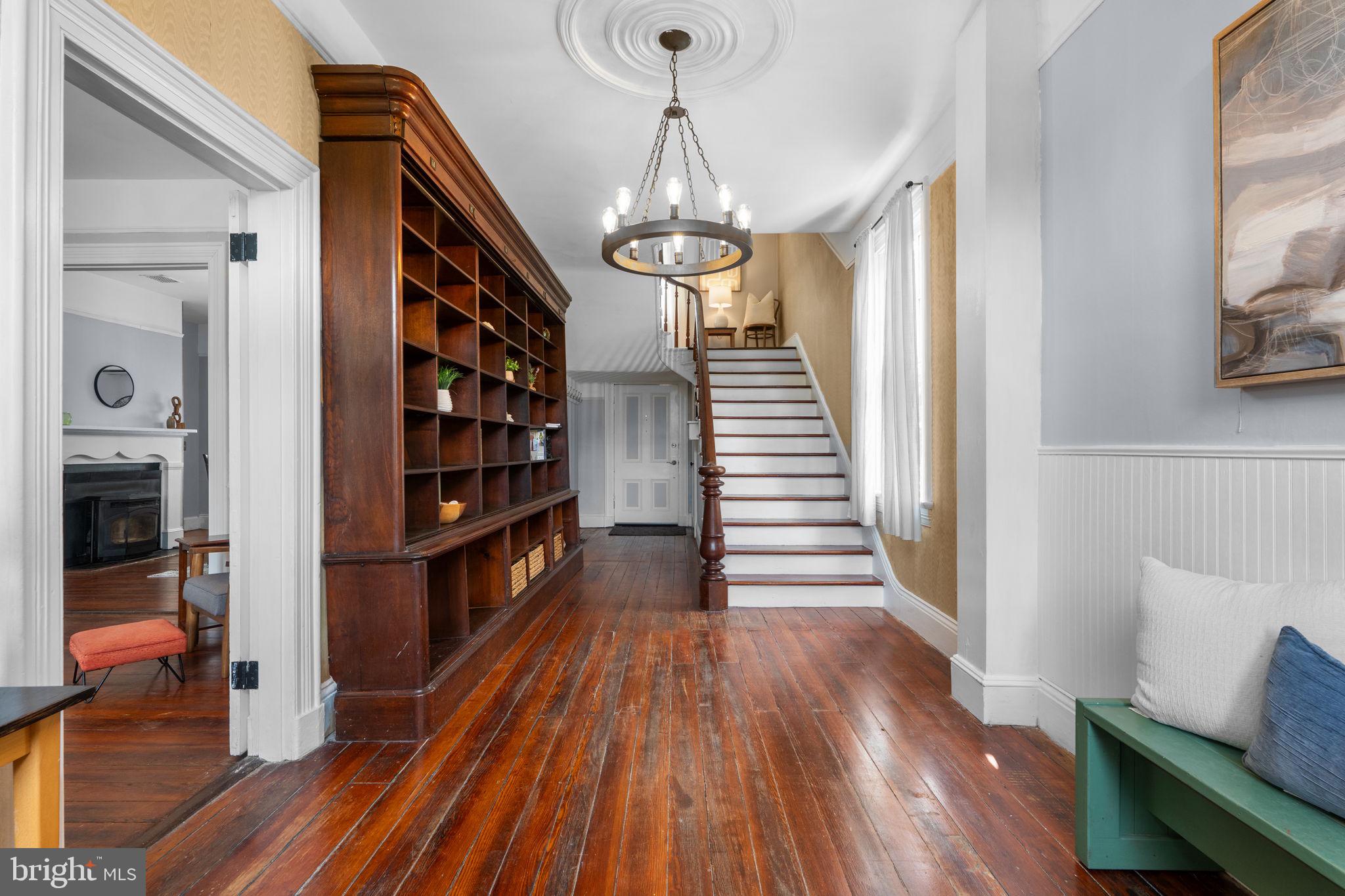 10007 Croom Road Upper Marlboro, MD 20772 - Photo 8 of 134 a view of a hallway with wooden floor and staircase