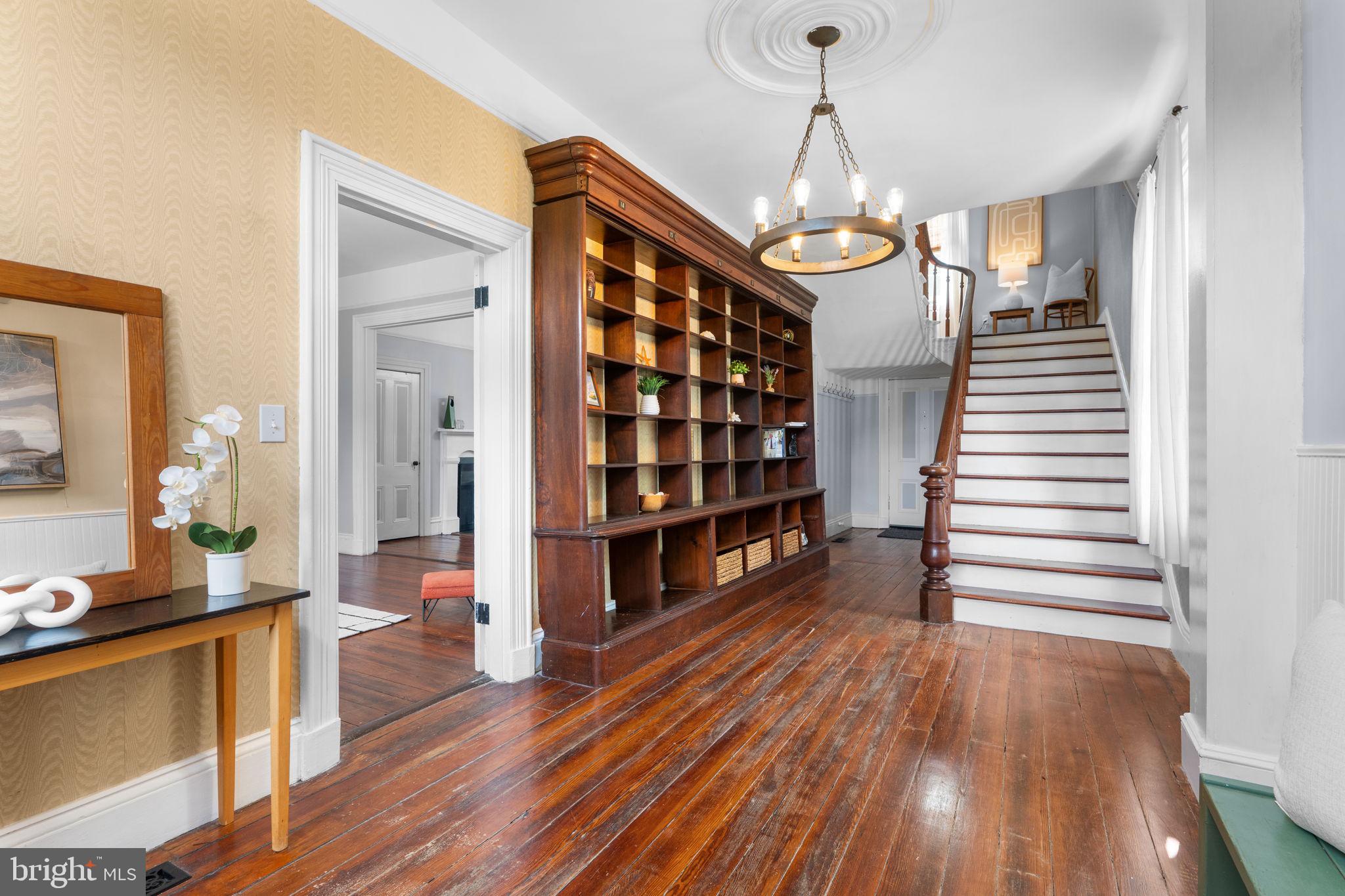 10007 Croom Road Upper Marlboro, MD 20772 - Photo 9 of 134 a view of a hallway with wooden floor and staircase