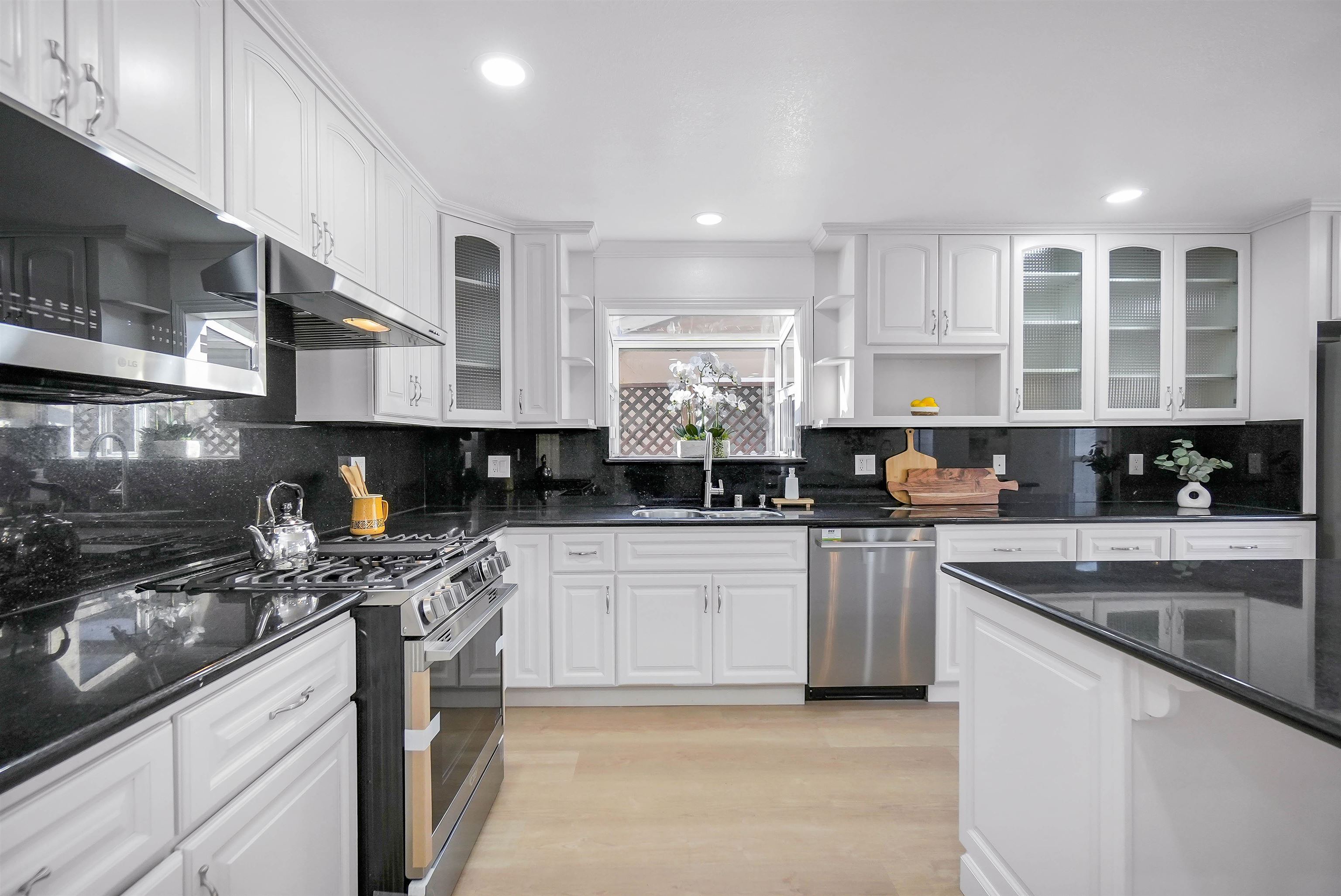 3159 Rowe Place Fremont, CA 94536 - Photo 44 of 59 a kitchen with stainless steel appliances granite countertop a stove a sink and a microwave
