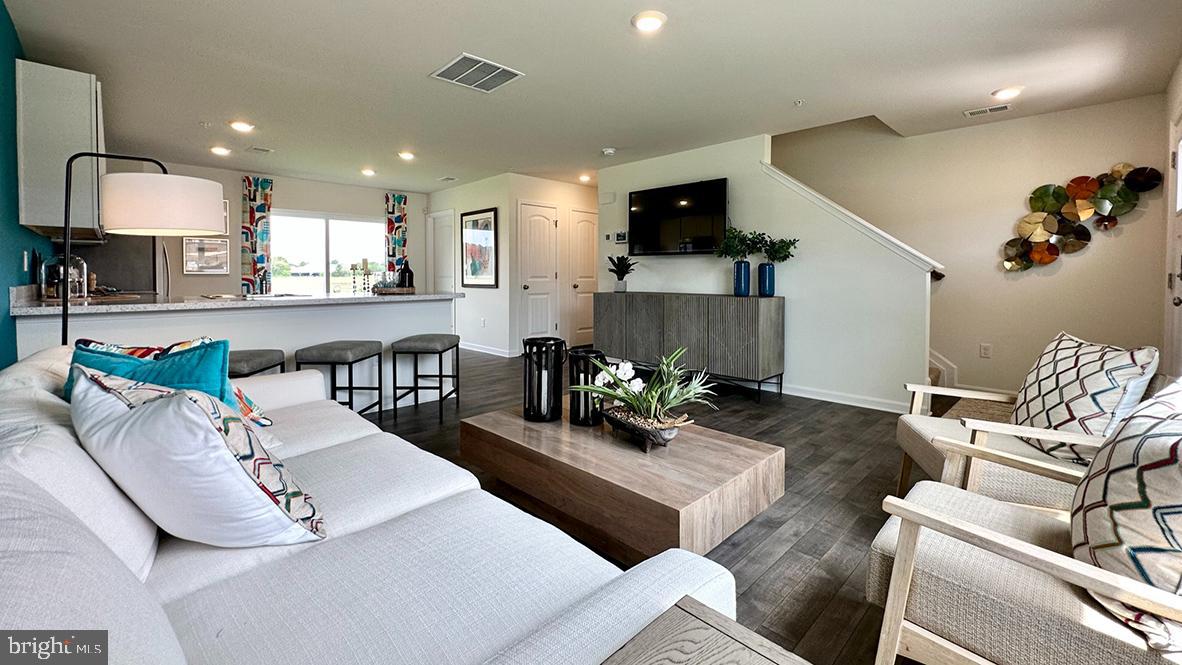 1152 Wintermead Loop Salisbury, MD 21801 - Photo 16 of 32 a living room with furniture and a wooden floor