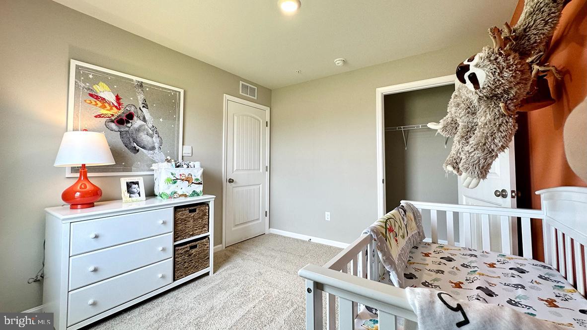 1152 Wintermead Loop Salisbury, MD 21801 - Photo 26 of 32 a view of a bedroom with baby crib and lounge chair