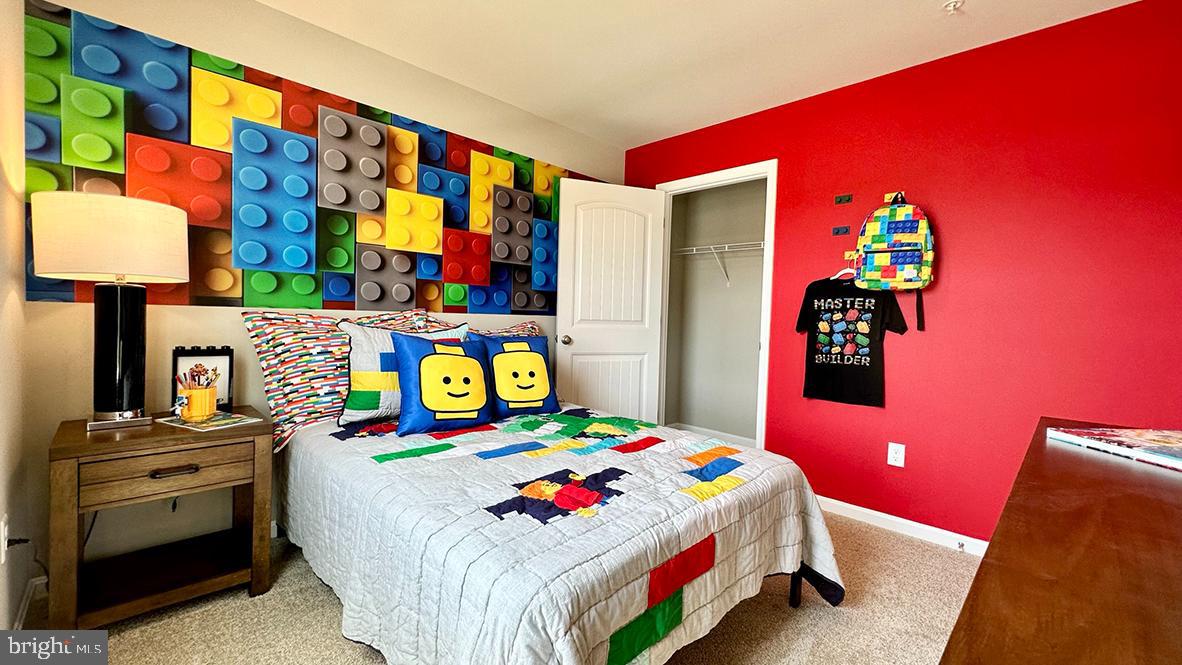 1152 Wintermead Loop Salisbury, MD 21801 - Photo 28 of 32 a bedroom with a bed and a lamp on dresser