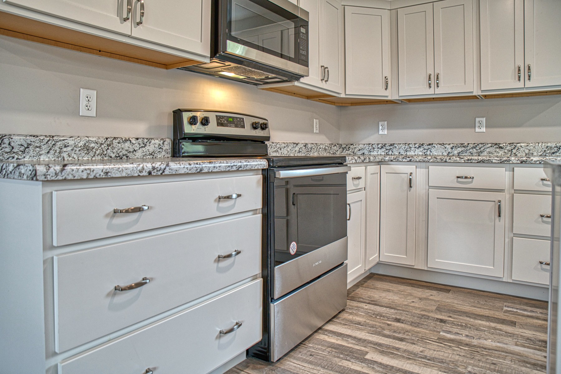 10309 Goff Ridge Road Baxter, TN 38544 - Photo 13 of 31 a kitchen with granite countertop white cabinets stainless steel appliances and sink