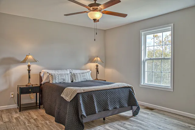a bedroom with a bed and a chandelier