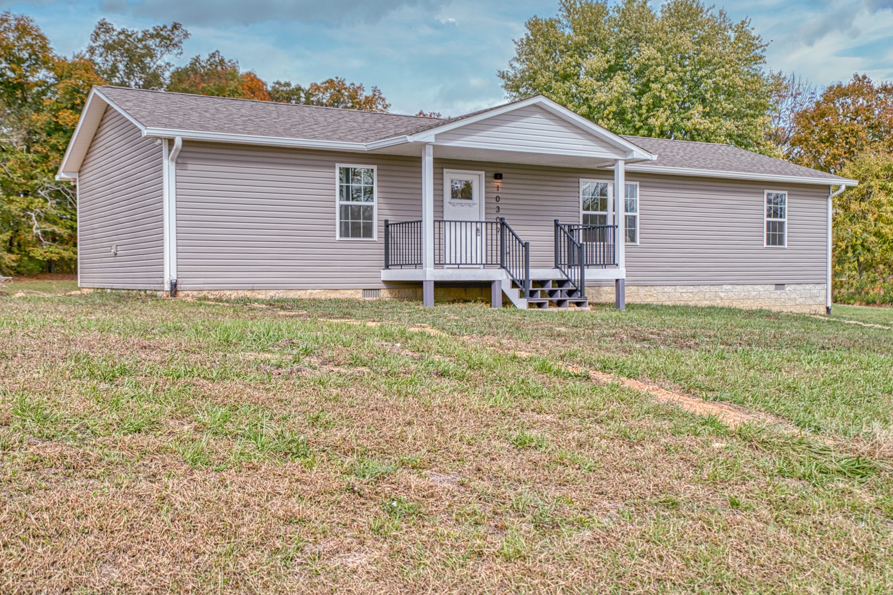 10309 Goff Ridge Road Baxter, TN 38544 - Photo 3 of 31 a backyard of a house with table and chairs