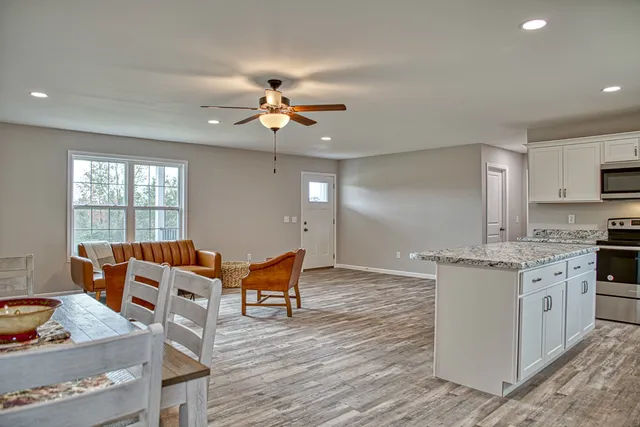 a view of a dining room with furniture and wooden floor