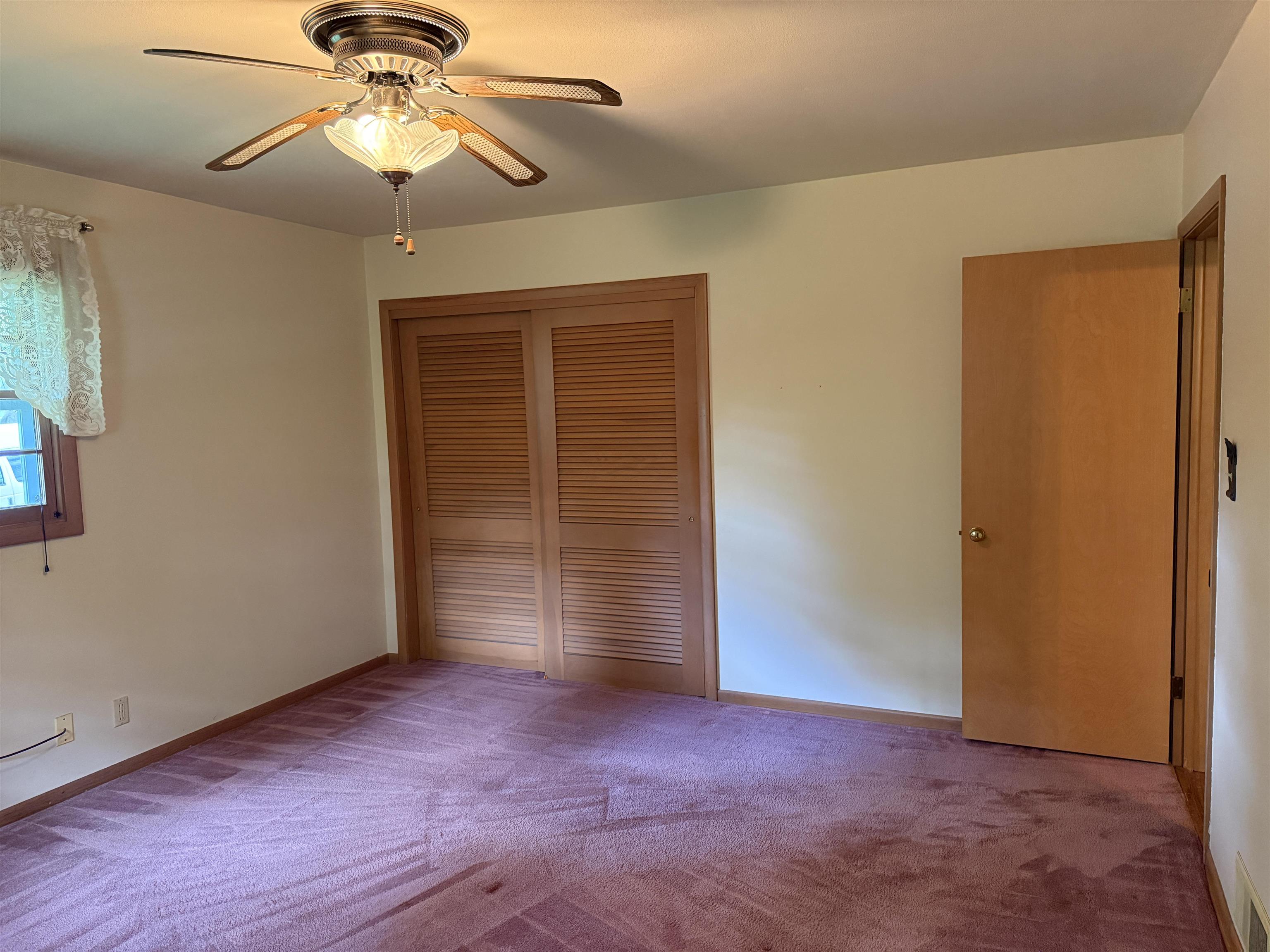 1894 North Ridge Drive Freeport, IL 61032 - Photo 9 of 25 an empty room with closet and a chandelier fan