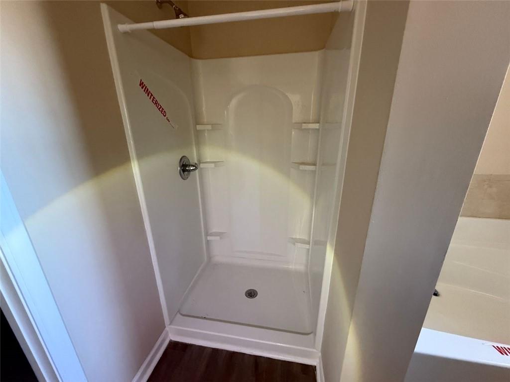 143 Massey Lane Locust Grove, GA 30248 - Photo 12 of 17 a bathroom with a glass door shower