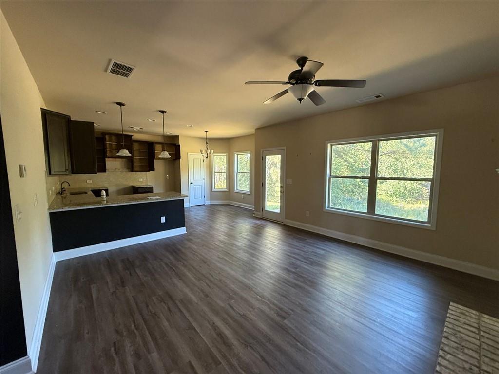 143 Massey Lane Locust Grove, GA 30248 - Photo 3 of 17 a large kitchen with cabinets wooden floor and stainless steel appliances
