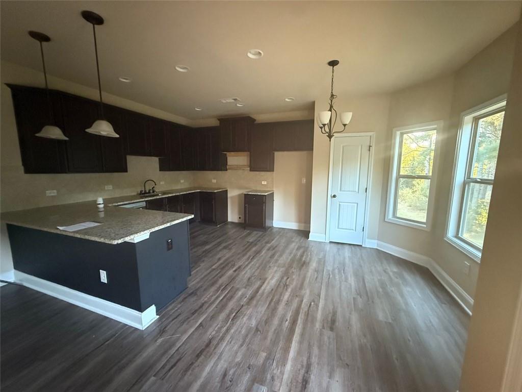 143 Massey Lane Locust Grove, GA 30248 - Photo 5 of 17 a kitchen with kitchen island a sink and a stove
