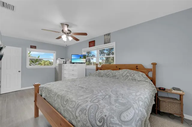 a bedroom with a bed and a chandelier