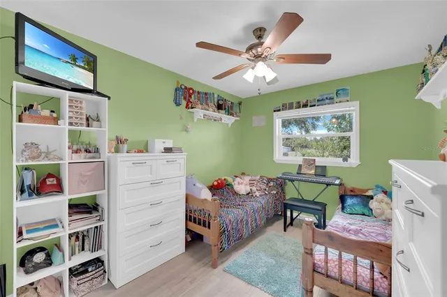 a bedroom with a baby bed a bookshelf and a bookshelf