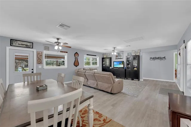 a living room with furniture and chandelier
