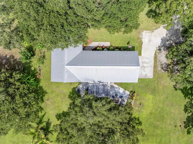 an aerial view of a house with a yard