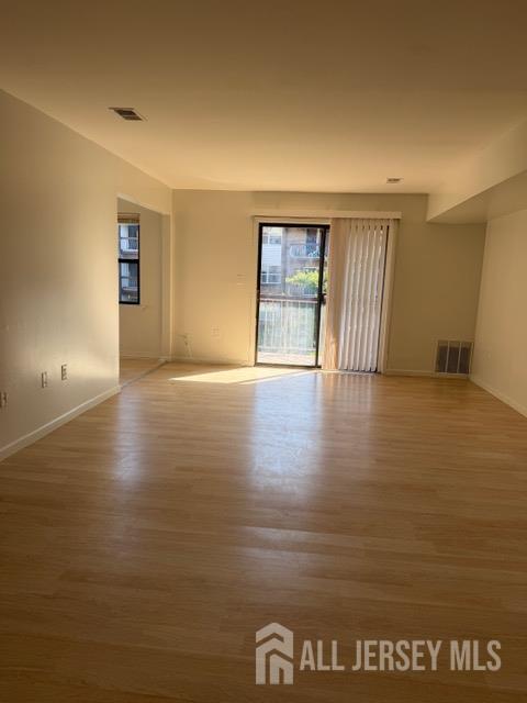 1508 Raspberry Court Edison, NJ 08817 - Photo 5 of 11 a view of an empty room with window and wooden floor