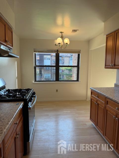 1508 Raspberry Court Edison, NJ 08817 - Photo 7 of 11 a kitchen with stainless steel appliances granite countertop a stove a sink and a refrigerator