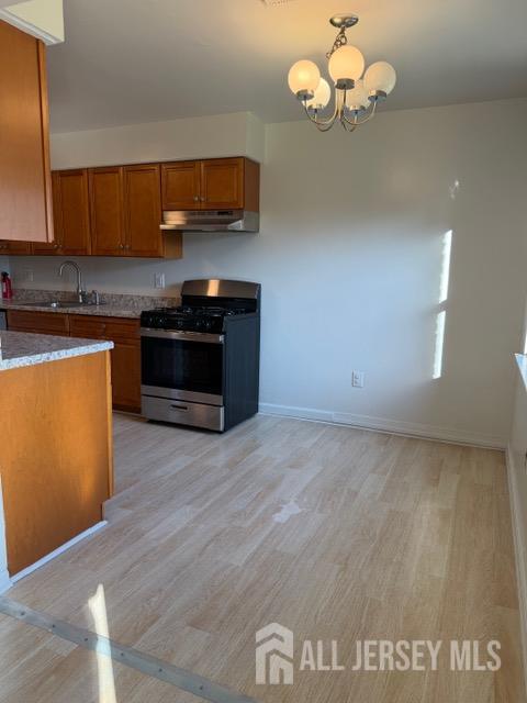 1508 Raspberry Court Edison, NJ 08817 - Photo 8 of 11 a kitchen with stainless steel appliances granite countertop a dishwasher a stove a microwave oven with cabinets and wooden floor
