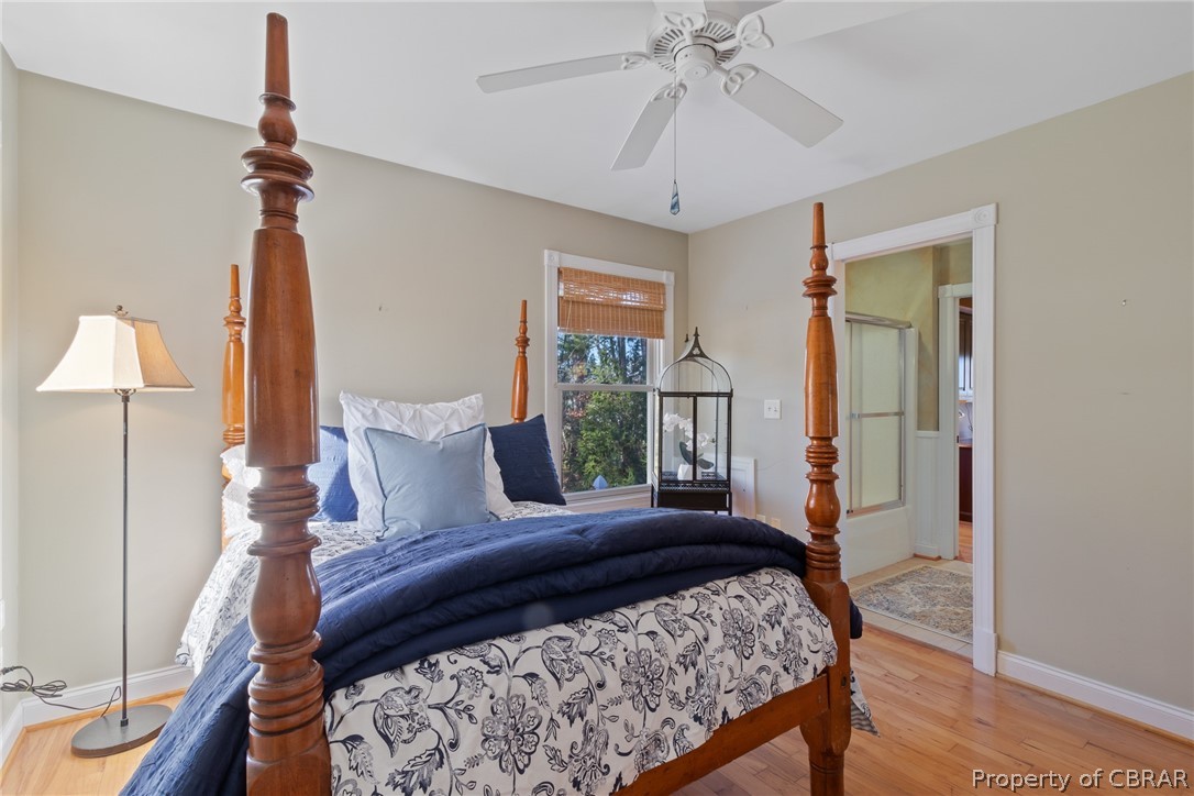 54 Murphy Street Reedville, VA 22539 - Photo 18 of 50 a bedroom with a bed chandelier and a window
