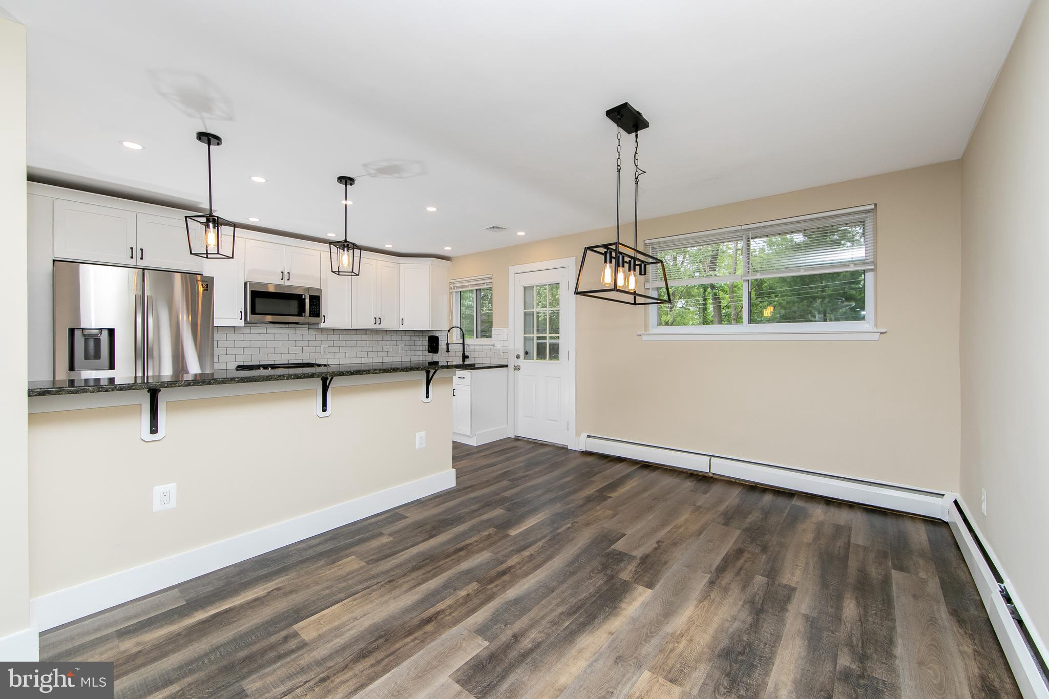 334 Parham Road Springfield, PA 19064 - Photo 11 of 41 a view of kitchen with stainless steel appliances refrigerator stove microwave and cabinets