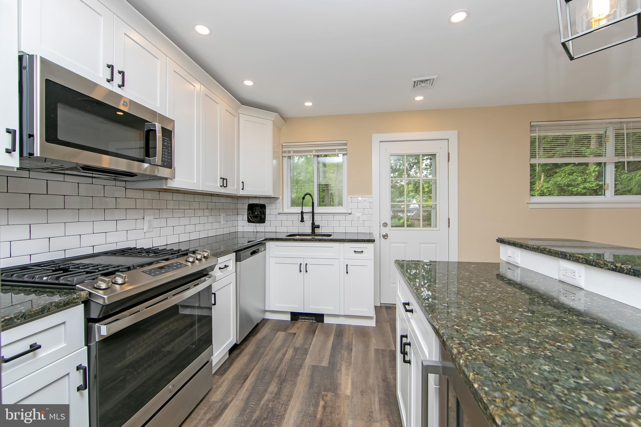 334 Parham Road Springfield, PA 19064 - Photo 14 of 41 a kitchen with stainless steel appliances granite countertop a stove and a microwave