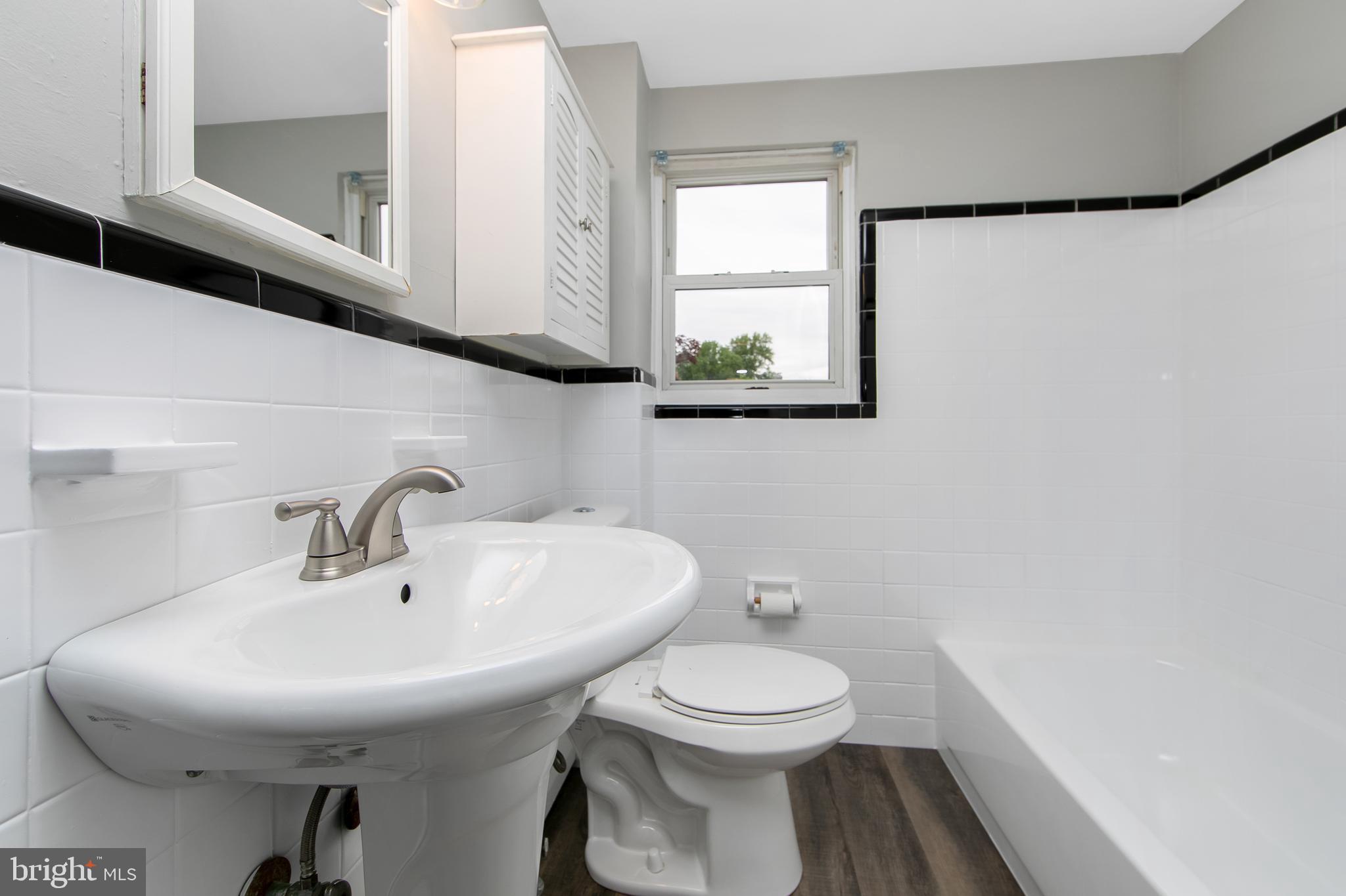 334 Parham Road Springfield, PA 19064 - Photo 21 of 41 a bathroom with a toilet a sink and a window