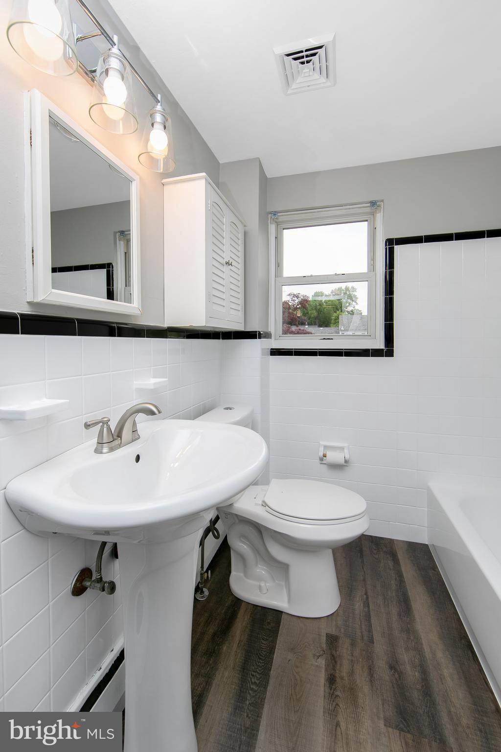 334 Parham Road Springfield, PA 19064 - Photo 22 of 41 a bathroom with a sink a mirror and a toilet