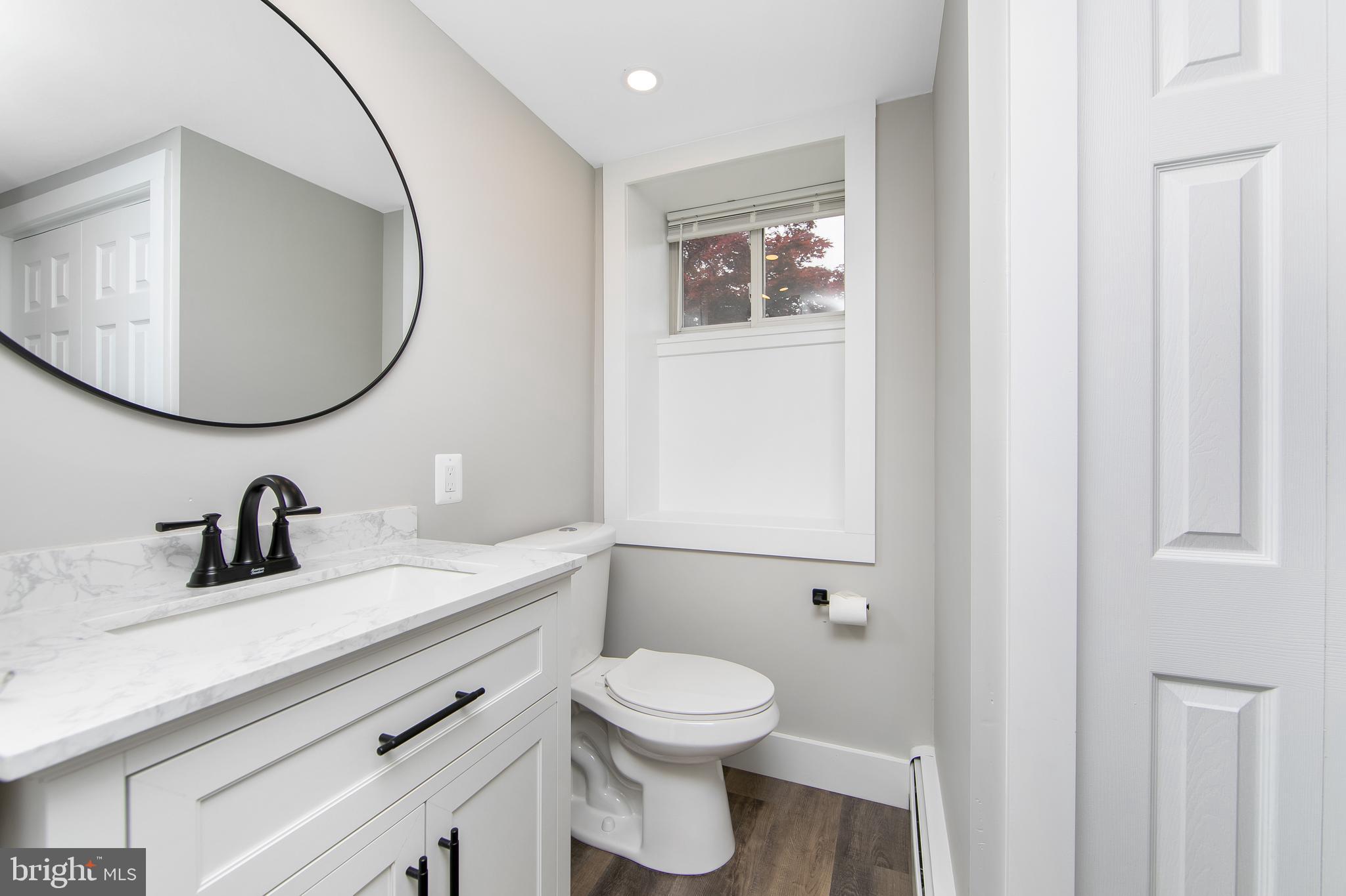 334 Parham Road Springfield, PA 19064 - Photo 27 of 41 a bathroom with a toilet a sink and mirror