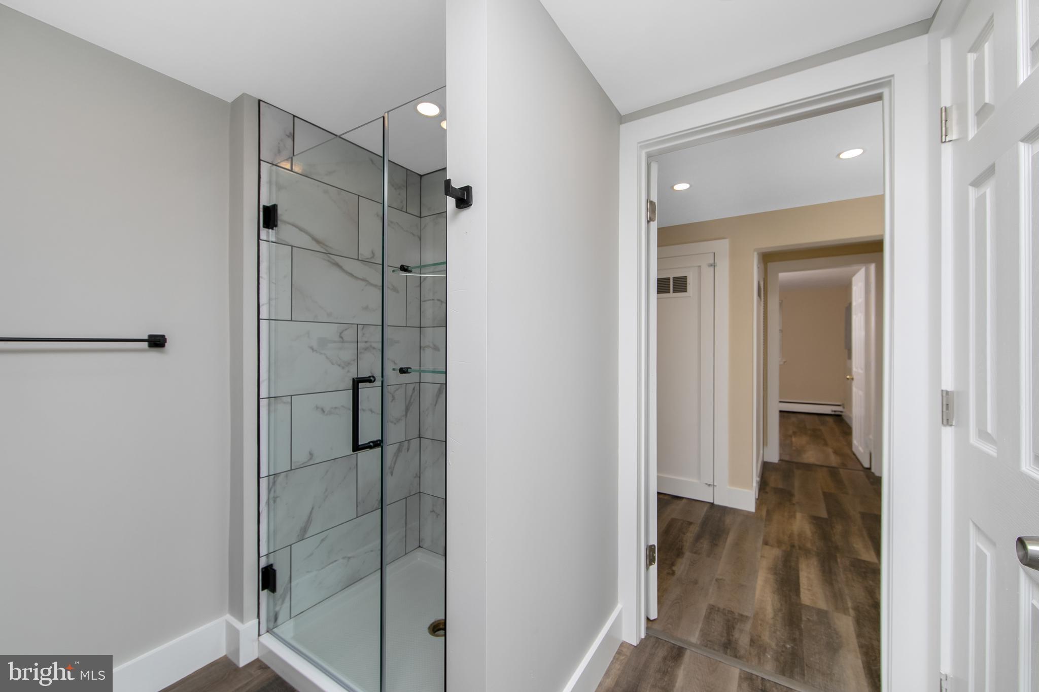 334 Parham Road Springfield, PA 19064 - Photo 28 of 41 a bathroom with a shower and a glass door