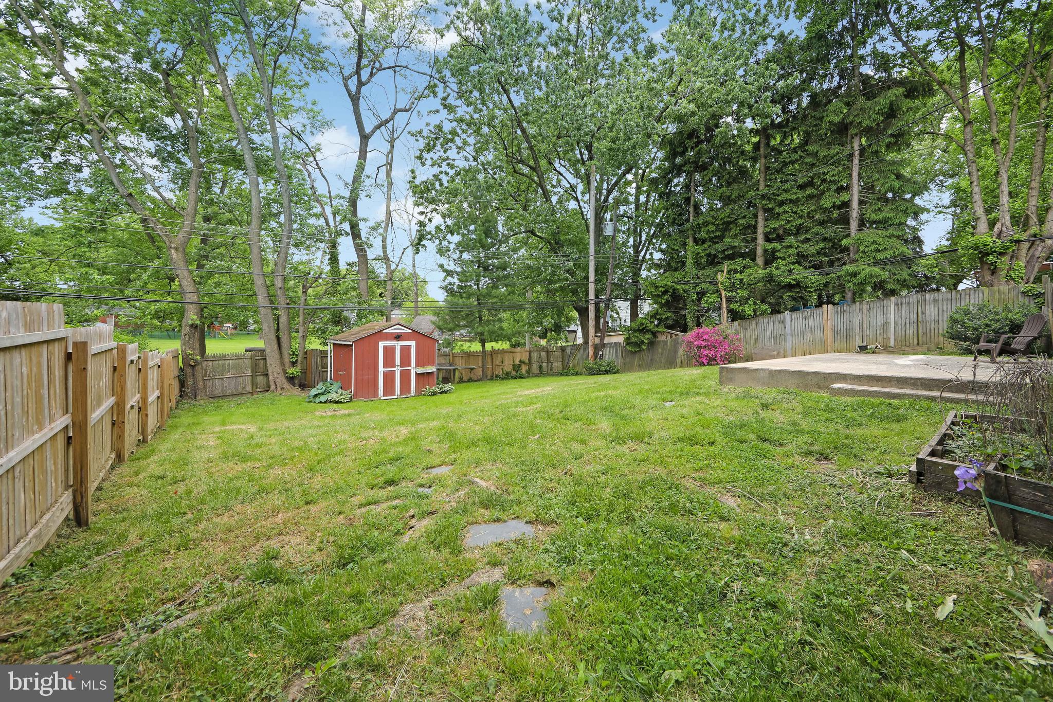 334 Parham Road Springfield, PA 19064 - Photo 33 of 41 a view of a backyard with large trees and plants