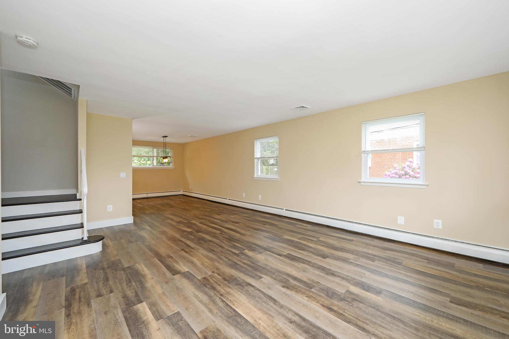 334 Parham Road Springfield, PA 19064 - Photo 9 of 41 an empty room with wooden floor and windows