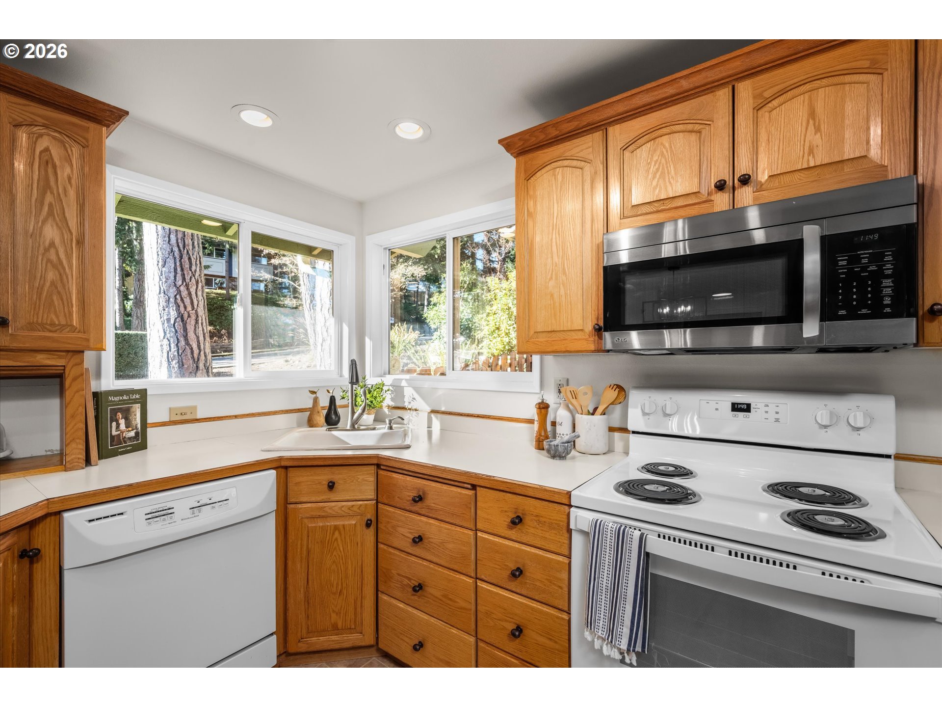 195 Coachman Drive Eugene, OR 97405 - Photo 11 of 34 a kitchen with stainless steel appliances a stove sink microwave and cabinets