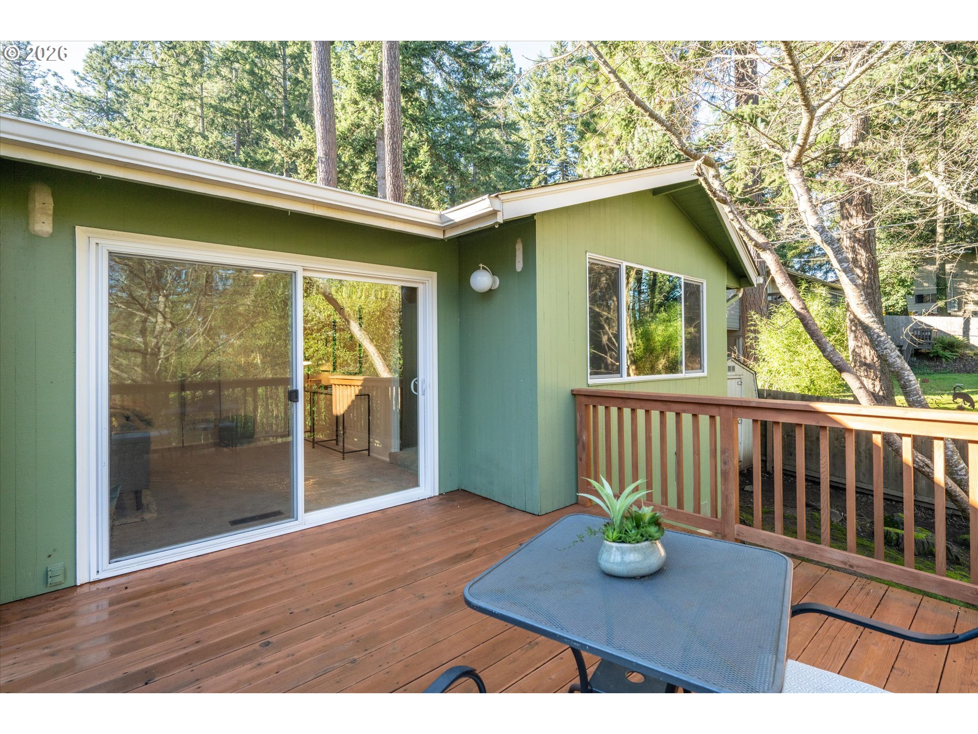 195 Coachman Drive Eugene, OR 97405 - Photo 4 of 34 a view of a deck with a table chairs and wooden floor