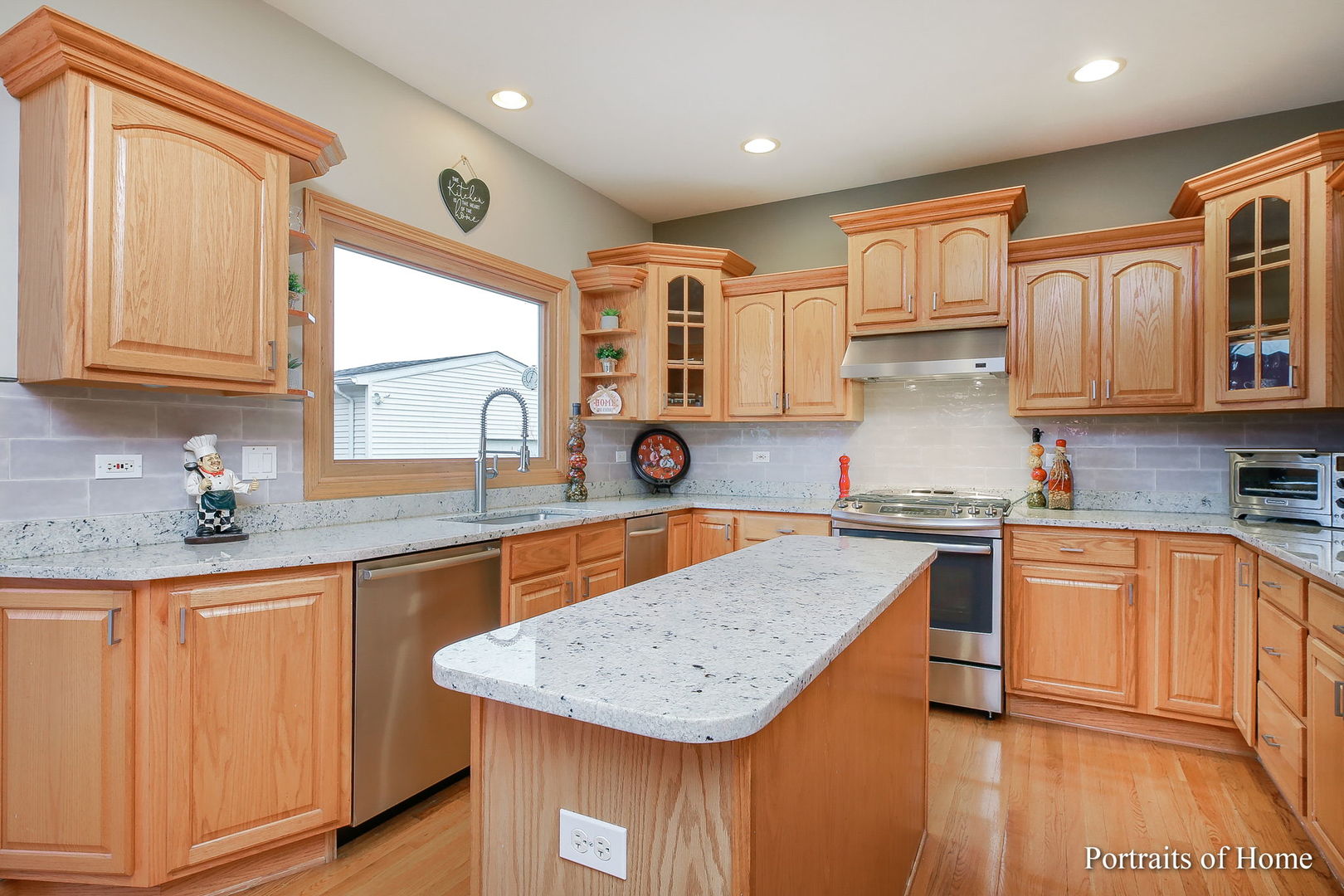 655 Mary Court Elmhurst, IL 60126 - Photo 11 of 46 a kitchen with stainless steel appliances granite countertop a sink stove and cabinets