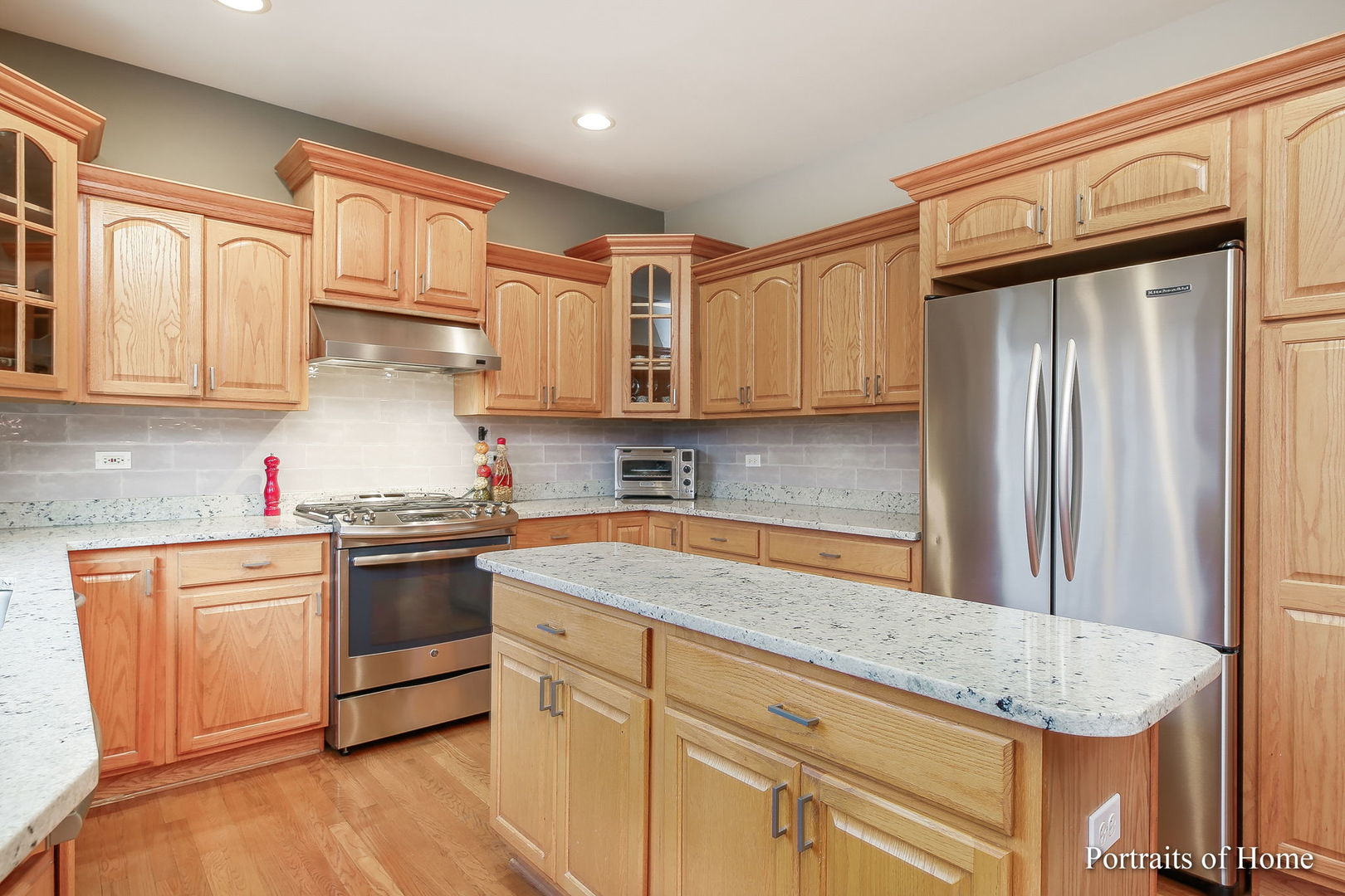 655 Mary Court Elmhurst, IL 60126 - Photo 8 of 46 a kitchen with stainless steel appliances granite countertop a sink stove and refrigerator