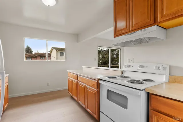 a kitchen with stainless steel appliances granite countertop a stove and a microwave