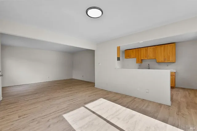 a view of a room with wooden floor and cabinet