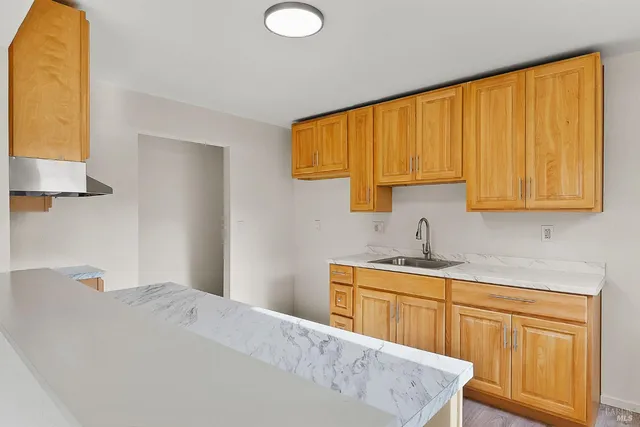 a kitchen with a sink a cabinets and window