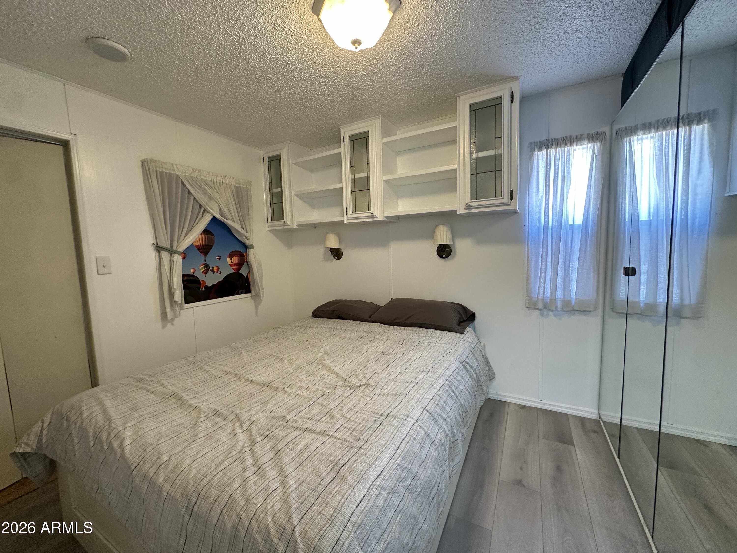 111 South Greenfield Road, Unit 575 Mesa, AZ 85206 - Photo 3 of 14 a bedroom with a bed and a window