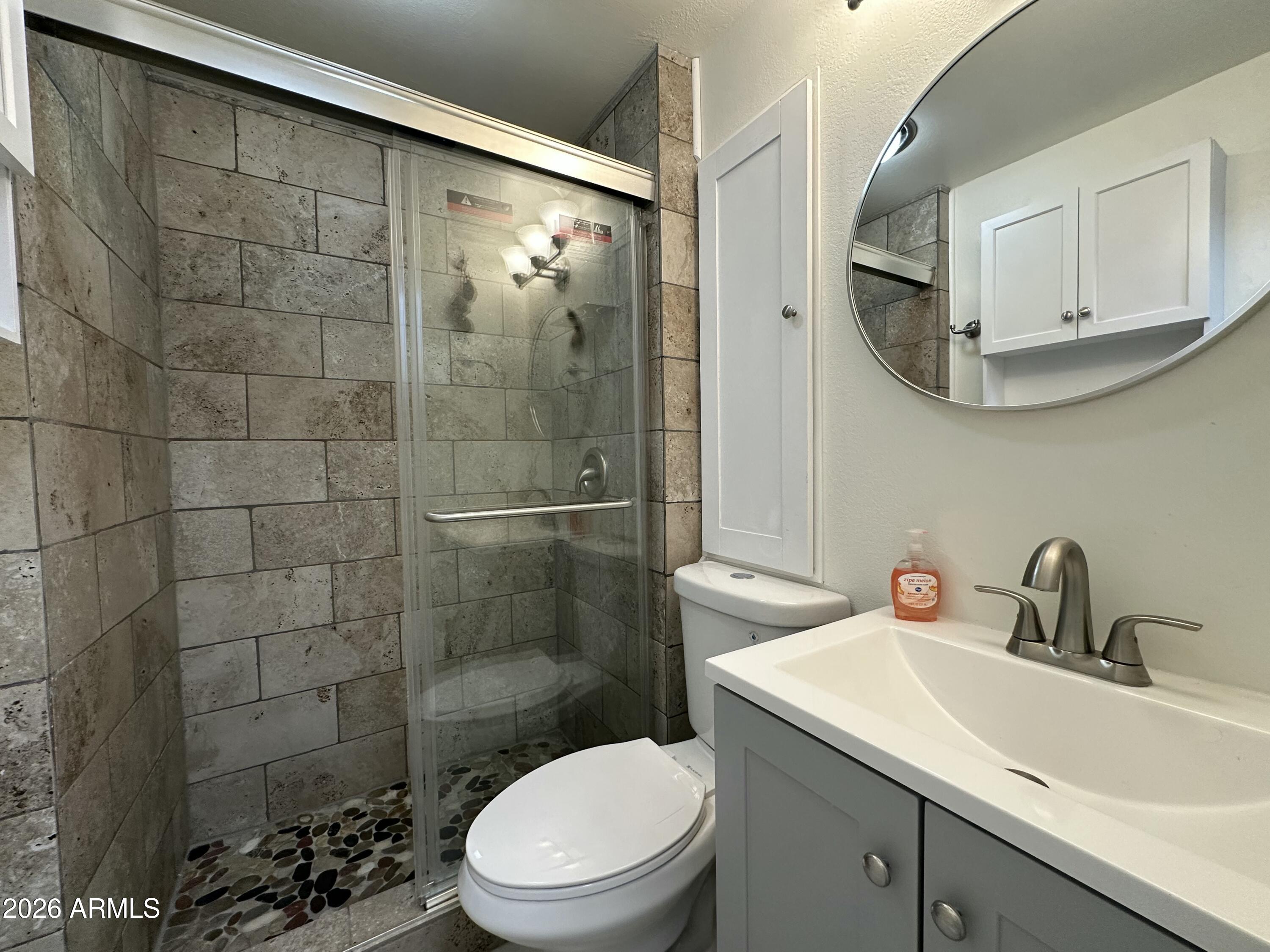 111 South Greenfield Road, Unit 575 Mesa, AZ 85206 - Photo 5 of 14 a bathroom with a sink a toilet and shower