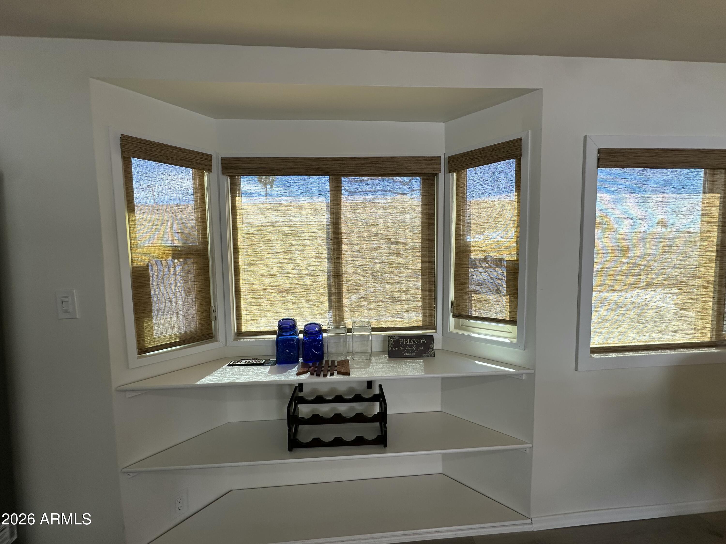 111 South Greenfield Road, Unit 575 Mesa, AZ 85206 - Photo 10 of 14 a living room with furniture and floor to ceiling windows