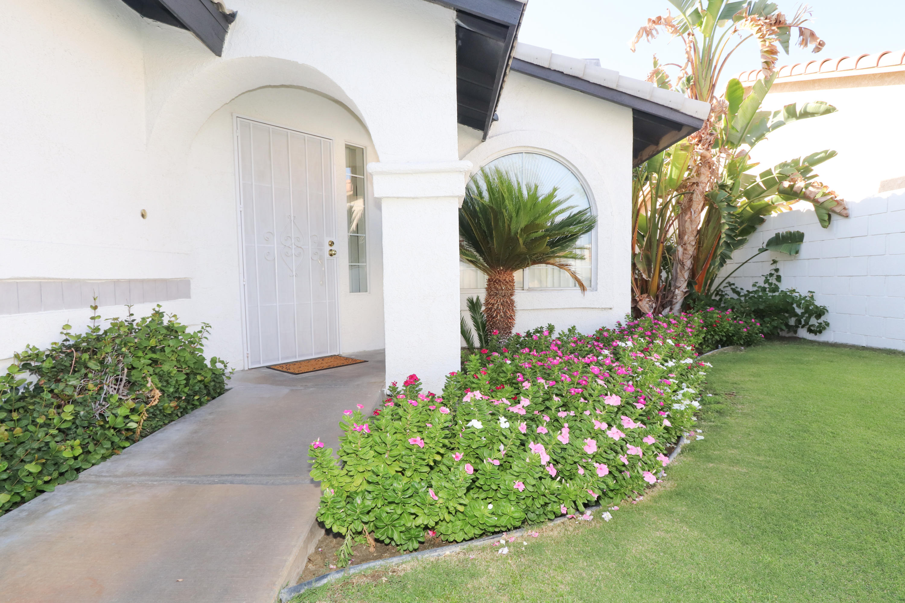 68250 Risueno Road Cathedral City, CA 92234 - Photo 2 of 19 a front view of a house with a yard