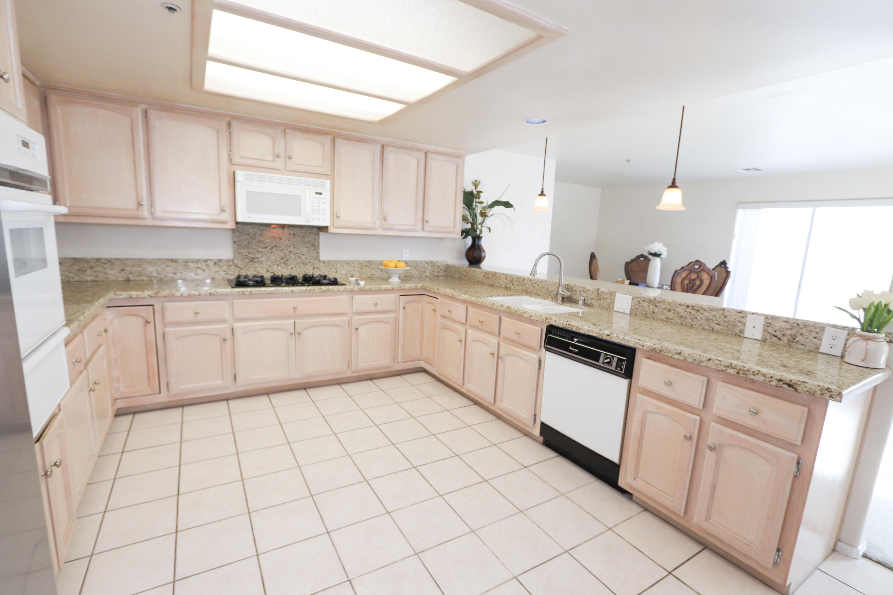68250 Risueno Road Cathedral City, CA 92234 - Photo 19 of 19 a kitchen with a sink window and cabinets